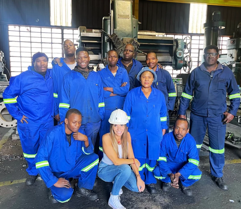 The Fedpump workshop team together in blue workwear