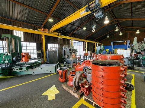 Fedpump workshop with orange pump casings and industrial machinery